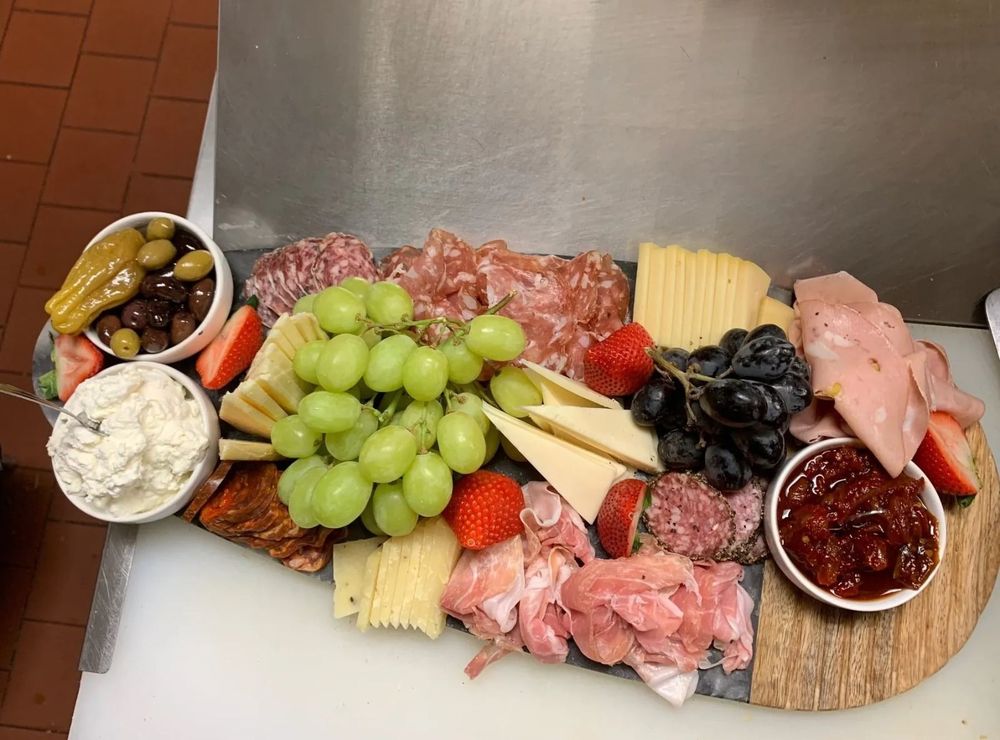 Charcuterie board with cured meats, cheeses and fruit