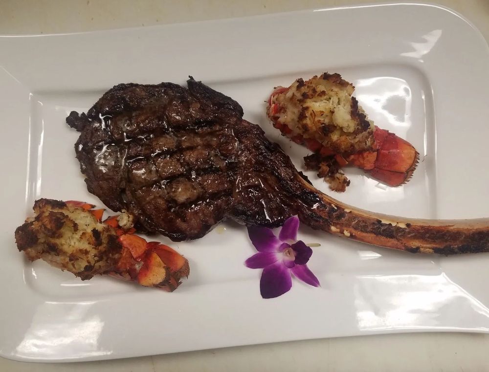 Steak with lobster tail plated in the dining room